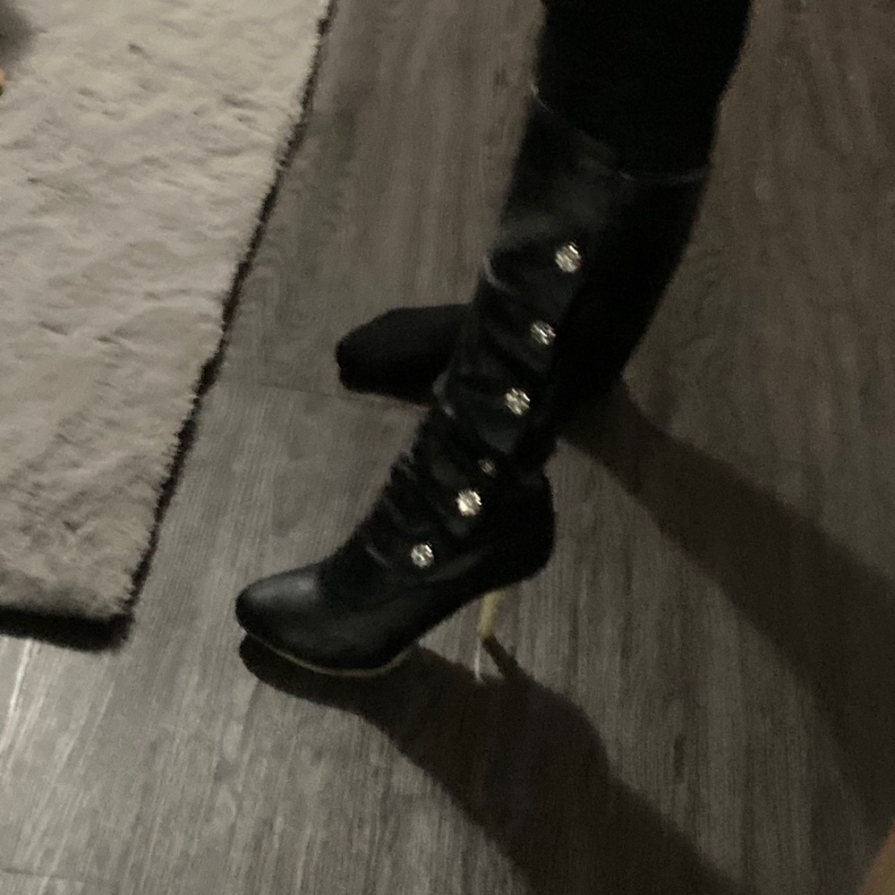 Black leather boots with rhinestones on side